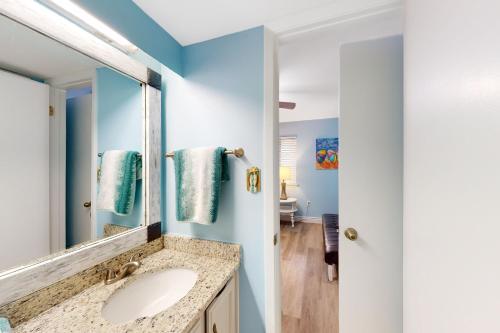 a bathroom with a sink and a mirror at Castaways 7C in Gulf Shores
