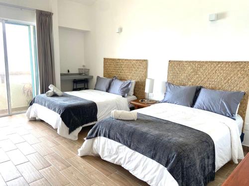a hotel room with two beds and a window at OceanView & Beach Access 3805 in Cancún