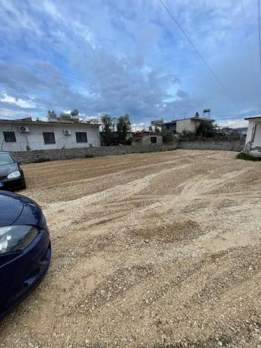 a dirt road with a car parked on it at Arial Penthouse Suites in Vlorë