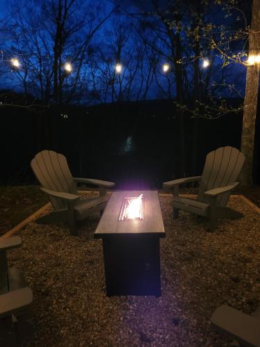 two chairs and a table at night with lights at Bears Hideaway in Pigeon Forge