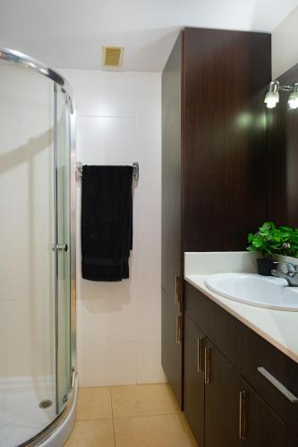a bathroom with a sink and a glass shower at Port de Xabia III in Jávea