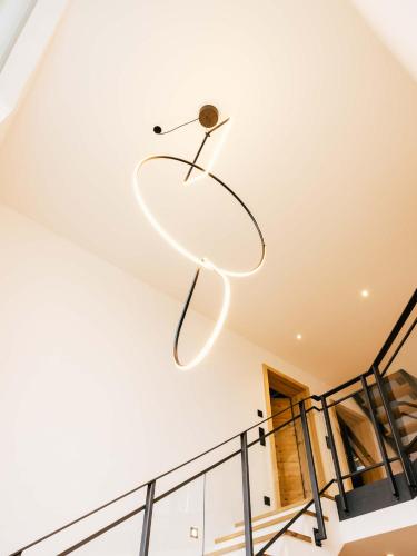a light fixture hanging from the ceiling of a staircase at Wolke 9A in Traunstein