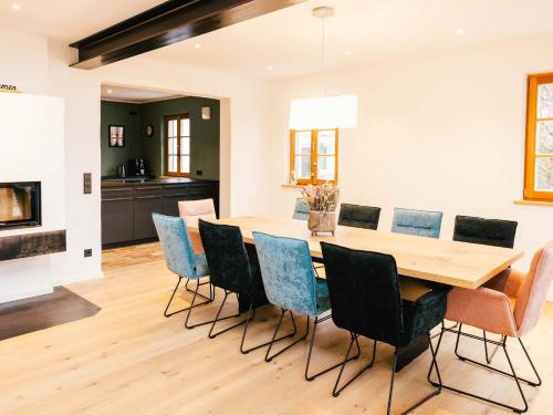 a dining room with a wooden table and chairs at Wolke 9A in Traunstein
