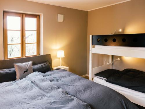 a bedroom with a bed and a bunk bed at Wolke 9A in Traunstein