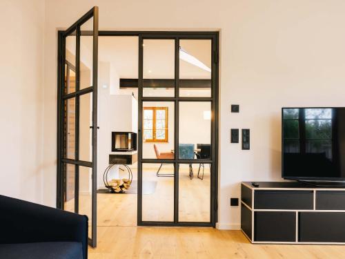 a living room with a glass door leading to a dining room at Wolke 9A in Traunstein