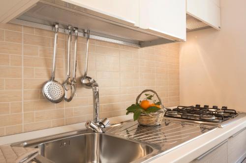 a kitchen with a sink and a stove at Villa Maria in Chiaramonte Gulfi