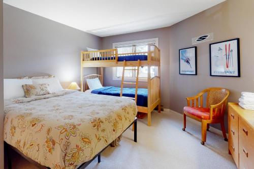 a bedroom with a bunk bed and a chair at Glades 20 in Warren