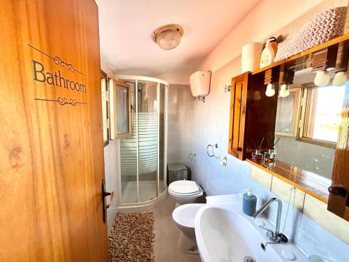 a bathroom with two sinks and a toilet and a shower at Casa40 Attico con terrazza in Rome