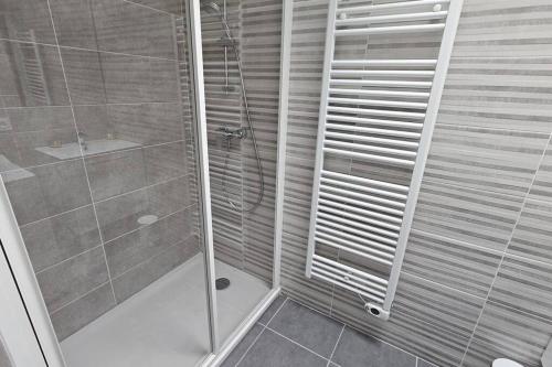 a shower with a glass door in a bathroom at La Grande Mouette in Thonon-les-Bains