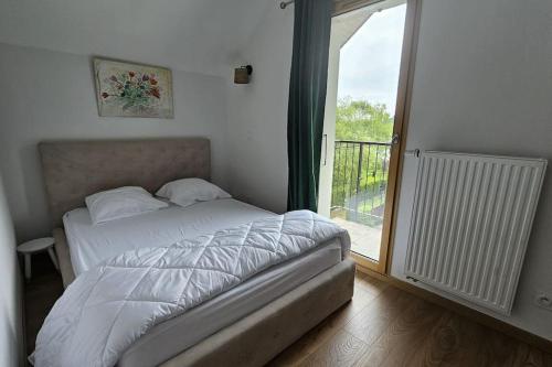 a bedroom with a bed and a door to a balcony at La Grande Mouette in Thonon-les-Bains
