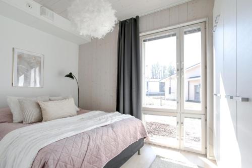 a bedroom with a bed and a large window at Woodrise Apartment 