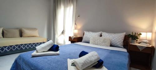a bedroom with two beds with blue and white at Little Hause in Psakoudia