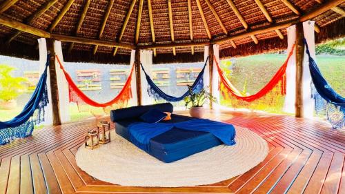 a bed in a hammock on a wooden deck at Recanto Jade in Taubaté