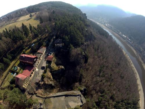 an aerial view of a house on a hill next to a river at Hotel Garni Belveder in Hřensko