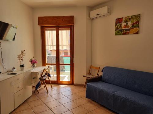 een woonkamer met een bank en een tafel en een keuken bij Rent an apartment in the picturesque Scalea, Italy in Scalea