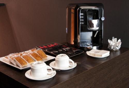 
a table topped with a cup of coffee and a microwave at Zenit Murcia in Murcia
