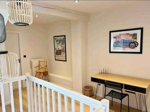 a living room with a piano and a table at Tres bel appartement le Concordance in Mulhouse