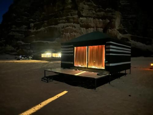 a small cabin in a parking lot at night at stars magic camp in Wadi Rum