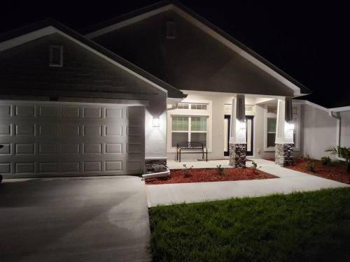 a house with a garage at night with lights at Home away from home in Port Charlotte