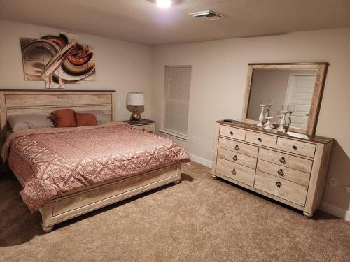 a bedroom with a bed and a dresser and a mirror at Home away from home in Port Charlotte