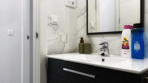 a bathroom with a sink and a mirror at La casita de Maria in Getxo