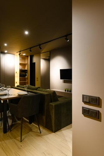 a living room with a green couch and a table at Luxury Apartments-Belochka in Uzhhorod
