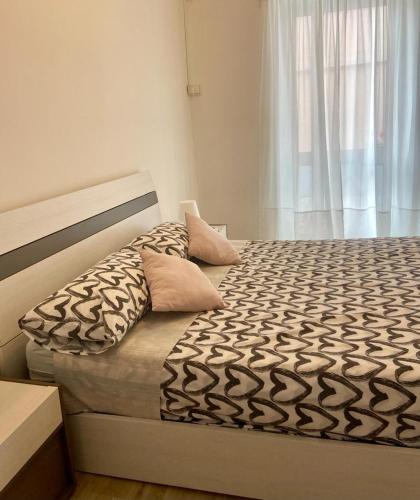 a bedroom with a bed and a window with a bedskirtspectspects at Casa Roma in Collegno