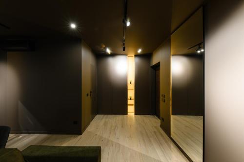 an empty corridor with black walls and wooden floors at Luxury Apartments-Belochka in Uzhhorod