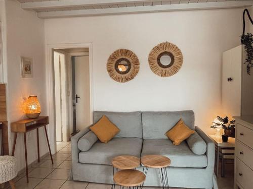 a living room with a blue couch and two tables at Cosy Home at Kalafatis beach - Cielo Homes in Kalafatis