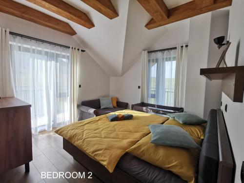 1 dormitorio con 1 cama grande y 1 sofá en Holiday Home Kamienok 2 en Liptovský Mikuláš