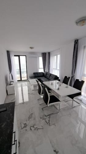 a white living room with a table and chairs at Diamond Beach Luxus Apart 22 Obzor in Obzor