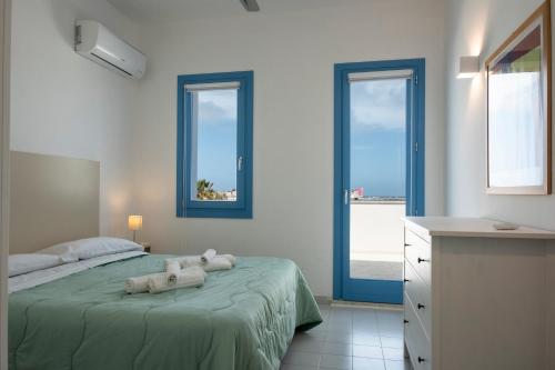 a bedroom with a bed with two stuffed animals on it at Casa Azzurra sul mare e centralissima in San Vito lo Capo
