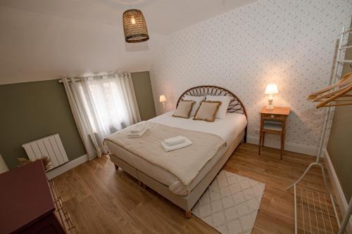 Ένα ή περισσότερα κρεβάτια σε δωμάτιο στο Le clos des voisins