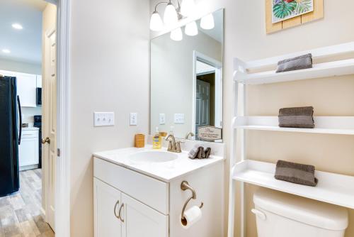 a white bathroom with a sink and a mirror at Pocono Lake Vacation Rental Community Amenities! in Pocono Lake