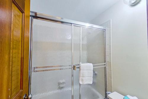 a shower with a glass door in a bathroom at Phoenix 209 in Steamboat Springs