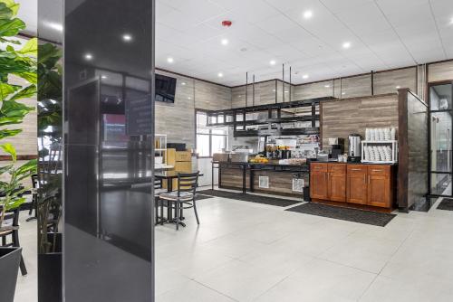 a large kitchen with wooden cabinets and a counter at Highbridge Hotel in Bronx