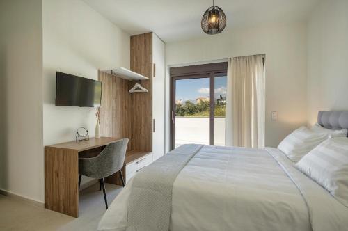 a bedroom with a bed and a desk and a window at Demar Exclusive Villa in Plakias