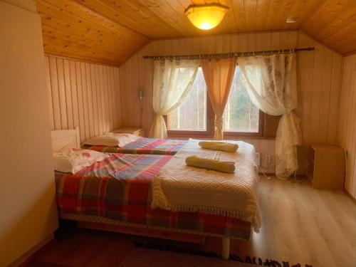 a bedroom with a bed in a room with a window at Kodikas Mökki in Ähtäri