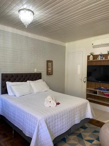 a bedroom with a bed with two towels on it at Casa no Vale dos Vinhedos em Bento Gonçalves in Bento Gonçalves