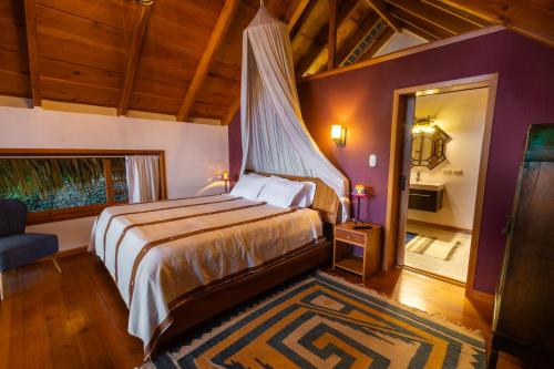 a bedroom with a king sized bed and a window at Balam Ya in Panajachel