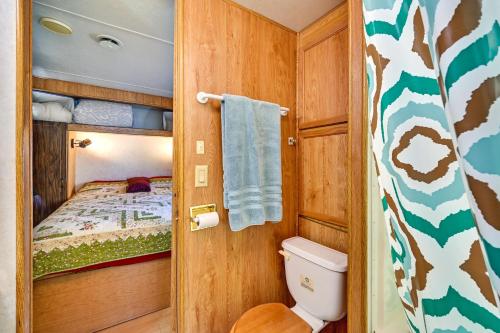 a small bathroom with a bed and a toilet at Yuma Getaway with Pool Access, 5 Mi to Lutes Casino! in Yuma