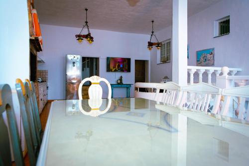 a dining room with a table and a chair at Hostel Blue Lagoon in La Mareta