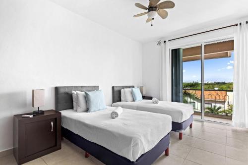 a hotel room with two beds and a window at 4 BR apartment, 8 guests in Cancún