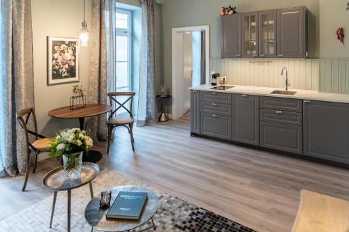 a kitchen with gray cabinets and a table at Villa Wickenburg in Salzburg