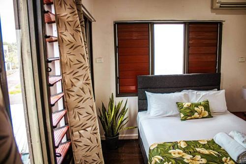 a bedroom with a bed and a window at Yaubula Accommodation in Nadi