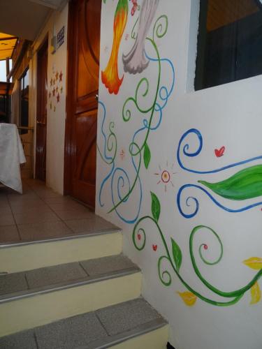 a wall with a peacock painted on it at Hostal Casa Del Inka in Cusco