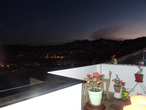 a balcony with a view of a city at night at Hostal Casa Del Inka in Cusco