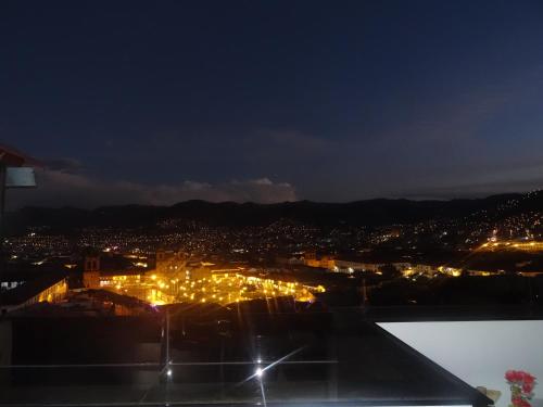 a view of a city at night with lights at Hostal Casa Del Inka in Cusco