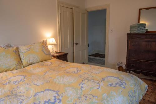 a bedroom with a bed and a dresser and a mirror at Parker Head House Popham Beach Phippsburg in Phippsburg