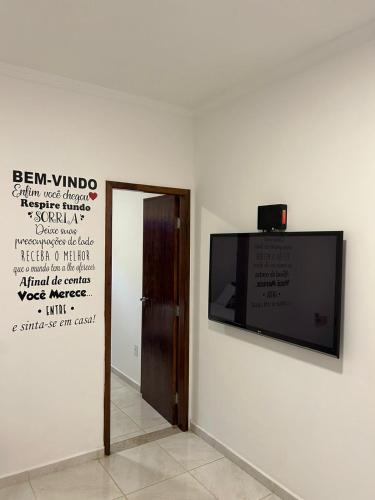 a flat screen tv on a wall in a room at BORA BORA RESIDENCE in Joinville